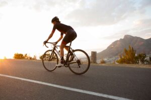 female cyclist riding early in the morning royalty free image 690329620 1552932768